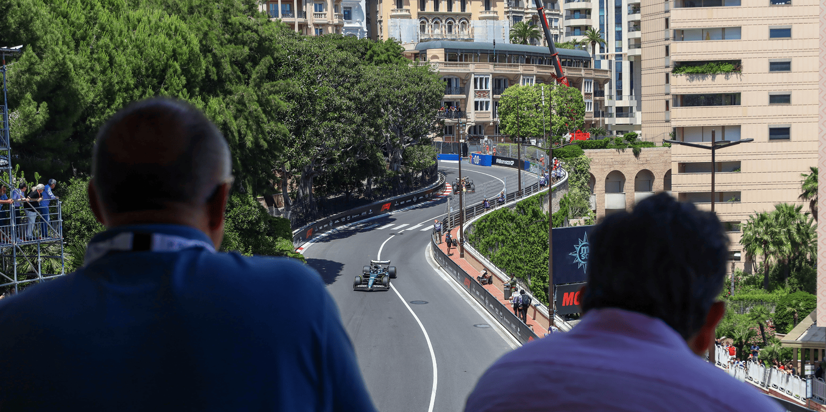 Fans watching the race cars from a balcony during the Formula One Monaco Grand Prix