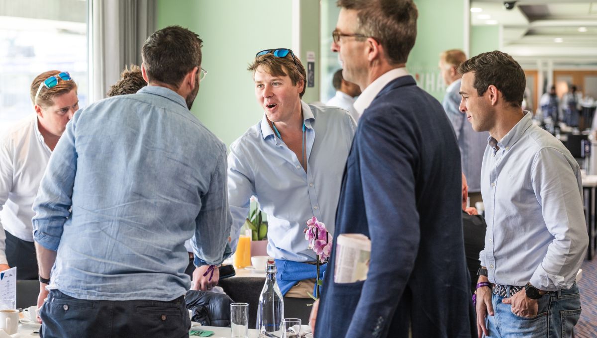 People greeting each other over drinks.